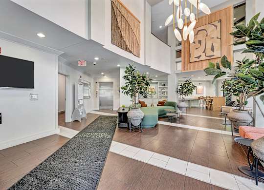A hallway with a black mat on the floor that says "ENTRANCE" in white letters.