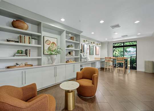 A living room with a white shelf, a brown chair, and a white table.