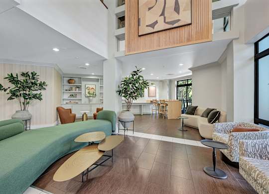 A modern living room with a green sofa and a wooden coffee table.