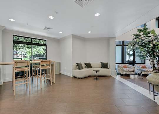 A spacious living room with a dining table and chairs.