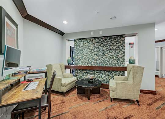 A room with a patterned wallpaper and a brown carpet.