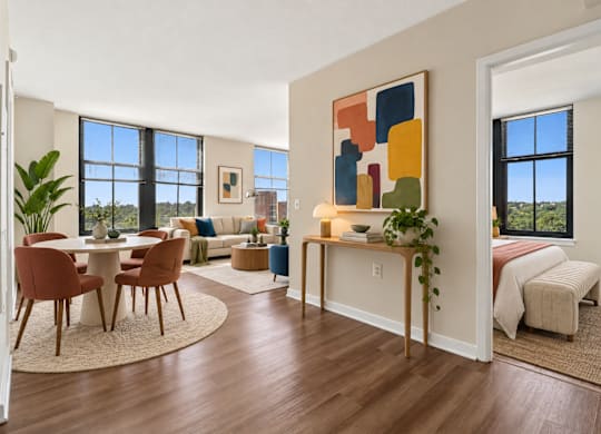 A modern living room with a dining table and chairs.