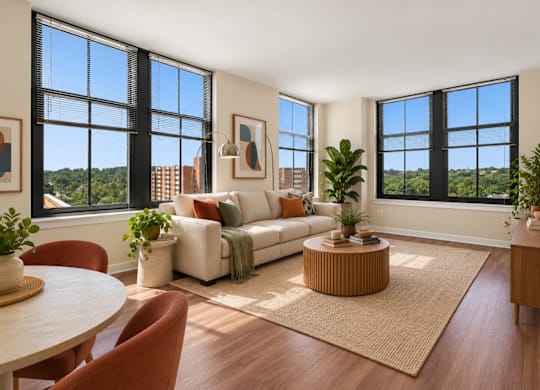 A living room with a white couch and a large window.