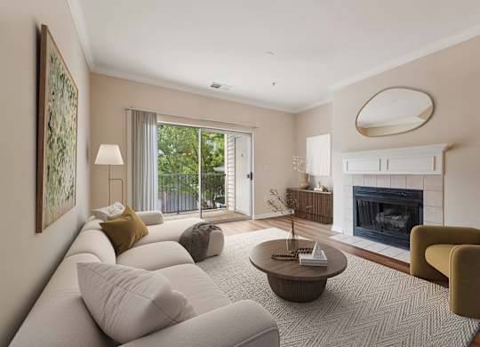 A living room with a fireplace and a painting on the wall.