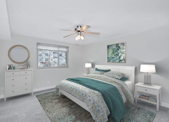 a bedroom with a bed and a ceiling fan