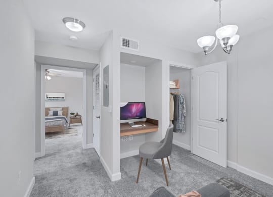 a bedroom with a desk and a closet