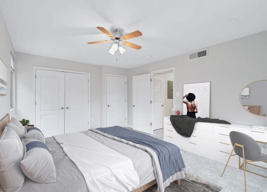 a bedroom with white walls and a white bed with gray pillows