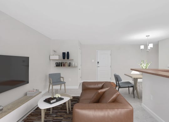 a living room with a brown couch and a white coffee table