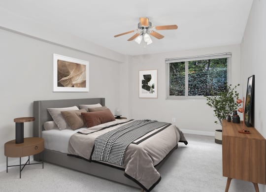 a bedroom with a bed and a ceiling fan