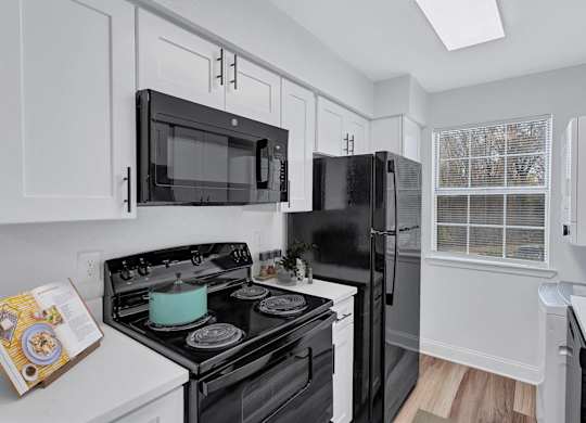 A black stove top oven with a blue pot on it.