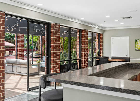 A kitchen with a black counter top and a white door.