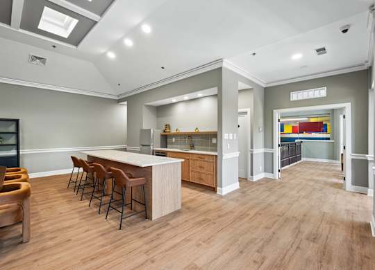 A modern kitchen with wooden floors and a bar area.