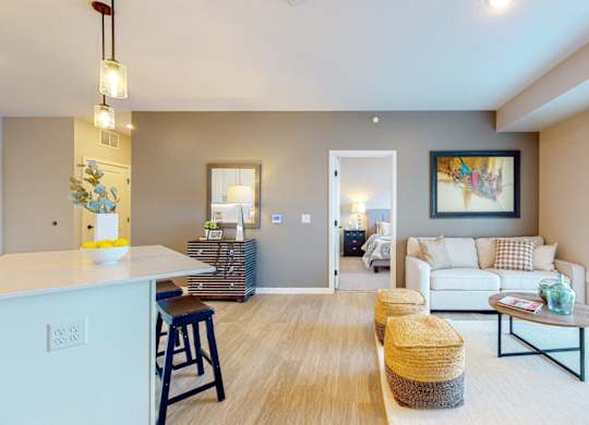 A living room with a white couch and a wooden floor.