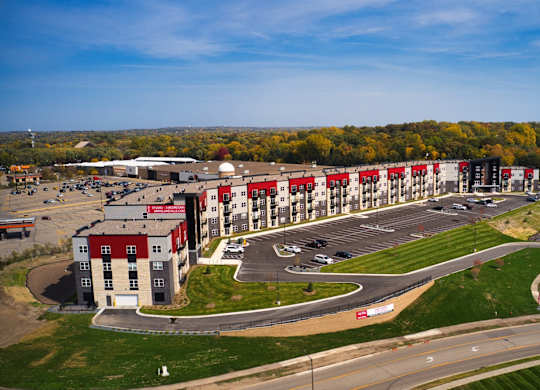 A large building with a parking lot in front of it.