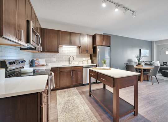 A modern kitchen with wooden cabinets and a central island.
