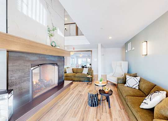 A modern living room with a fireplace and a couch.
