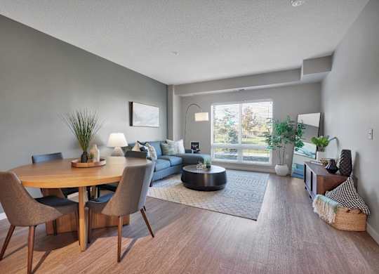 A modern dining room with a wooden table and chairs.
