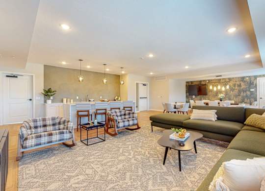 A living room with a couch, chairs, and a coffee table.