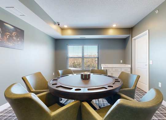 A round table with six chairs around it in a room.