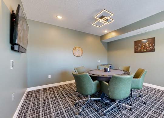 A conference room with a table surrounded by chairs.