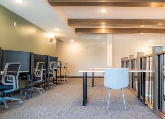 A conference room with a white table and chairs.
