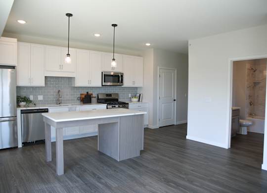 a kitchen and dining area in a 555 waverly unit