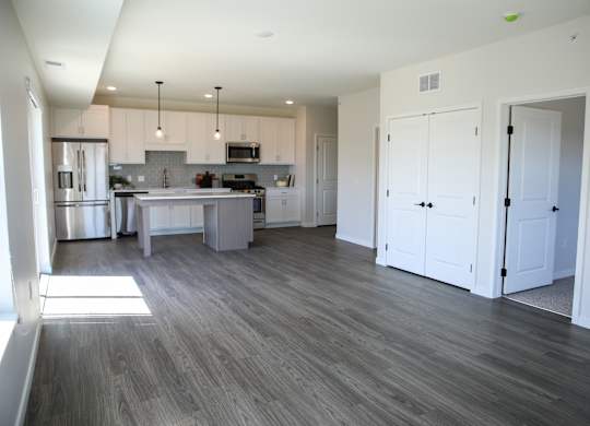 a kitchen and living room in an apartment