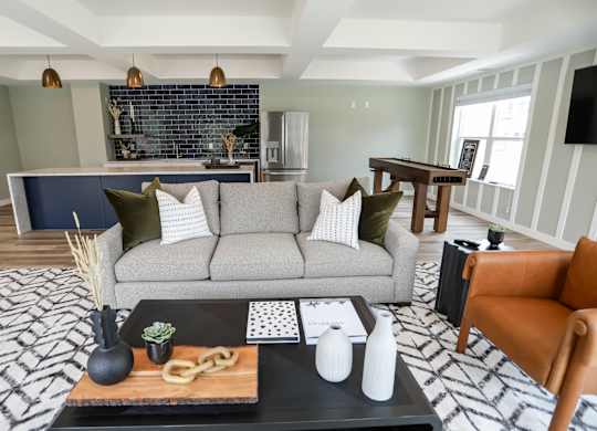 a living room filled with furniture and a large window