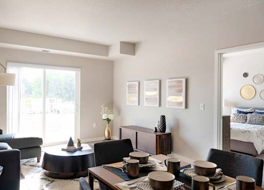 A modern living room with a dining table set for four.