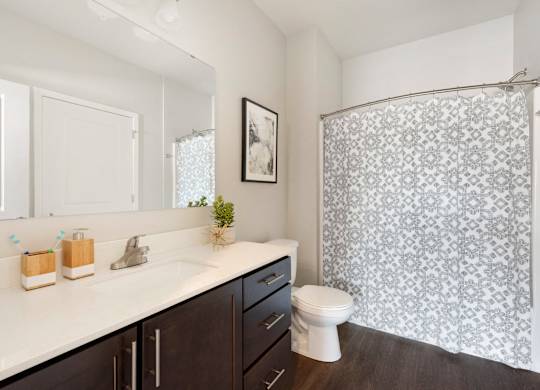 A bathroom with a white sink and a toilet.