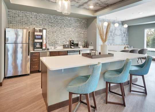 A modern kitchen with a marble ceiling and a central island.