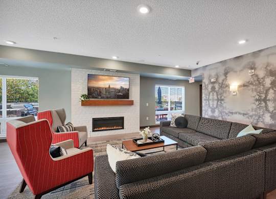 A living room with a fireplace and a painting on the wall.