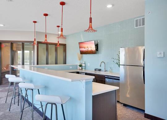 A kitchen with a blue wall and a stainless steel refrigerator.