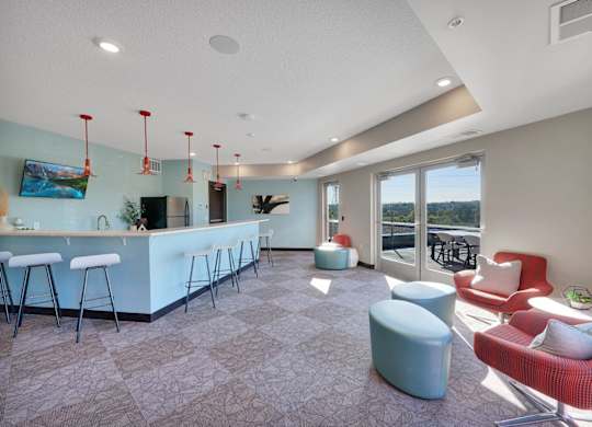 A modern living room with a bar area and comfortable seating.