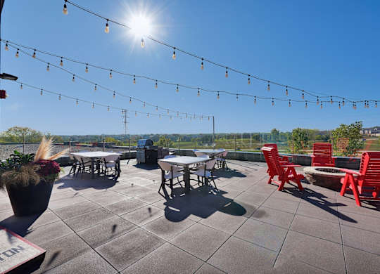 A sunny day at an outdoor seating area with tables and chairs.