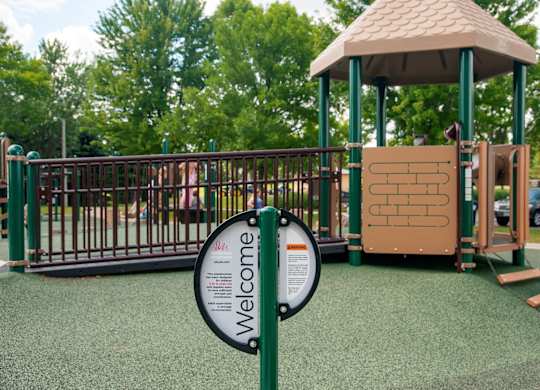A playground with a sign that says