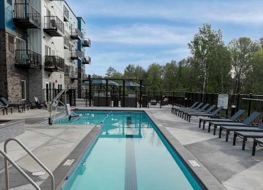 A long rectangular pool with a metal ladder on the side.