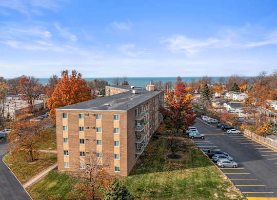 A large building with a parking lot in front of it.