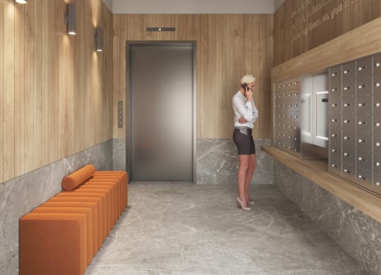 a woman standing in a hallway with a door to a locker room at East 4th Street, Cleveland, 44115