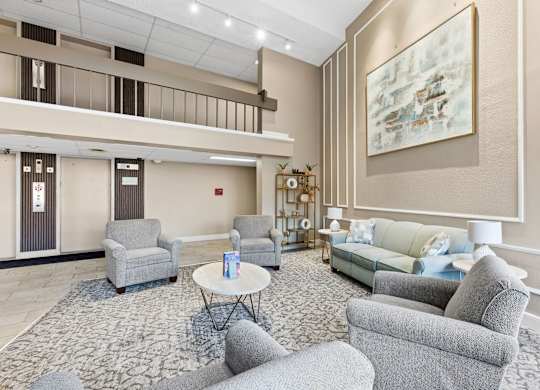 A living room with grey chairs and a white coffee table.