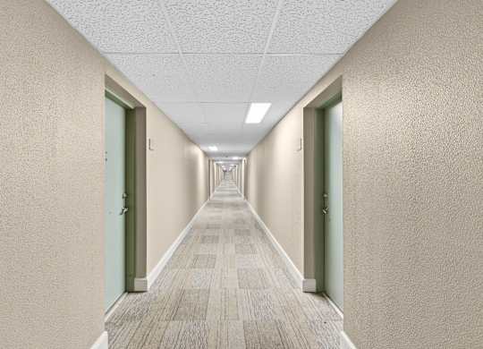 A long hallway with doors on both sides.