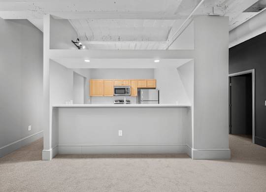 A large open space with a kitchenette in the middle.