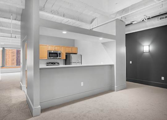 A kitchen area with a microwave and oven.