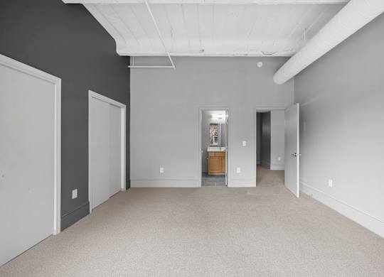 A large empty room with a door in the middle.