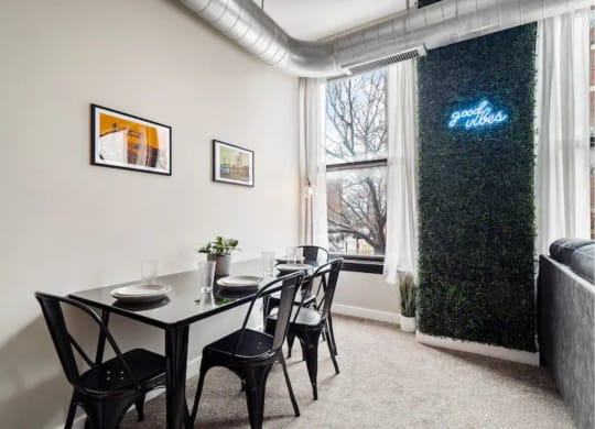 a dining room with a table and chairs and a window