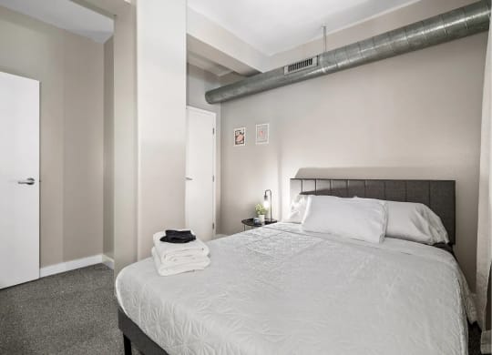 a bedroom with a large bed and a closet