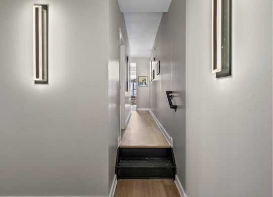 a long hallway with white walls and a long wooden counter top
