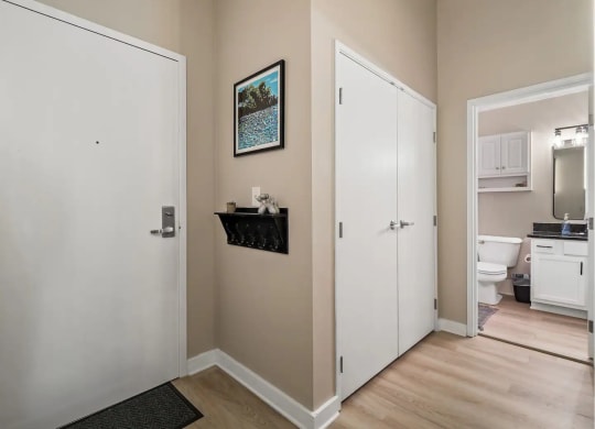 a room with a door to a bathroom and a closet