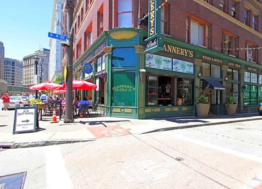 a city street with a green building on the corner at East 4th Street, Ohio, 44115