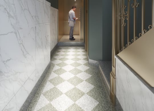 a man standing in a hallway with a door to a hotel room at East 4th Street, Ohio, 44115
